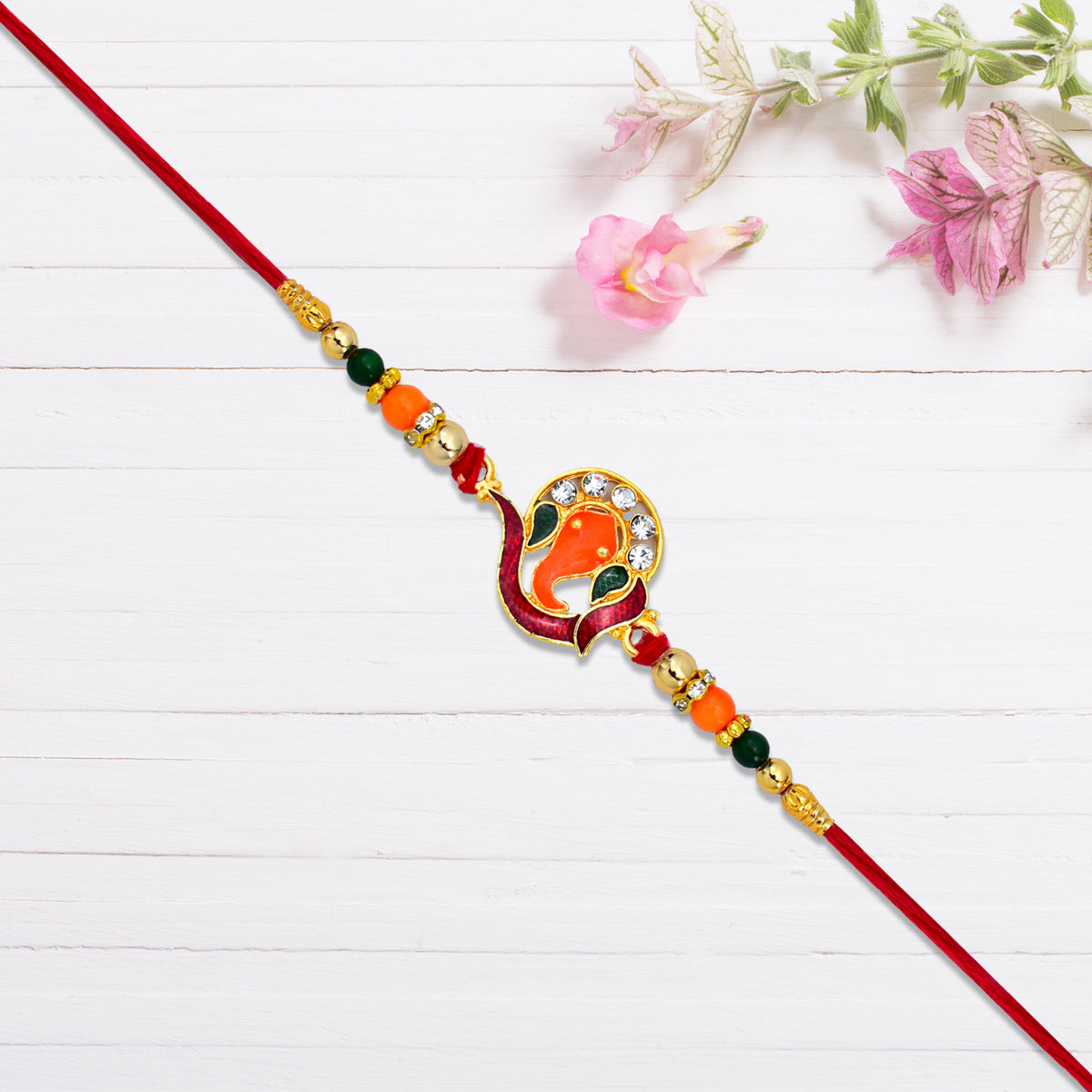 Golden Ganesha Rakhi With Red-green Beads And Stone Detailing